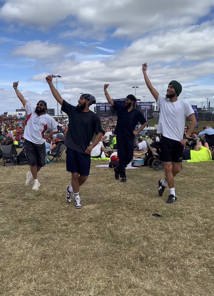 Four LU Bhangra dancers performing at an outdoor festival